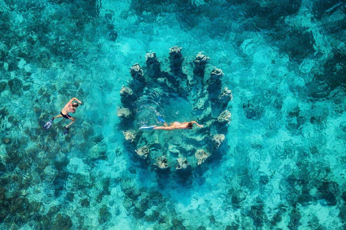 Aerial view of snorkelers and turquoise water around Gili Meno on a snorkeling trip from Bali